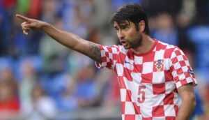 Croatian defender Vedran Corluka gestures during the Euro 2012 championships football match Italy vs Croatia on June 14, 2012 at the Municipal Stadium in Poznan. AFP PHOTO / FABRICE COFFRINI (Photo credit should read FABRICE COFFRINI/AFP/GettyImages)